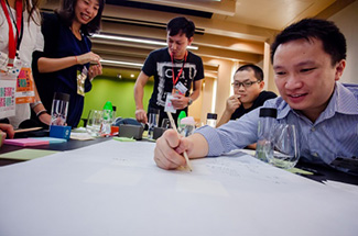 Photo:A team writing their ideas on a piece of vellum